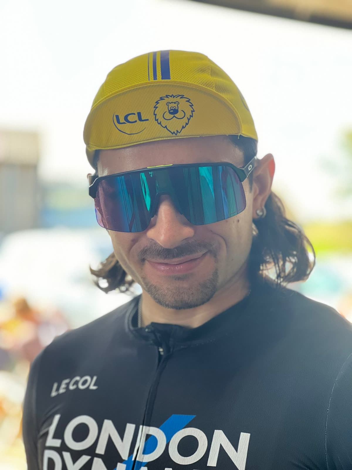 Portrait of Rodrigo smiling in a cycling cap and sunglasses